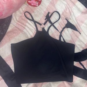 Black crop top with metal ring in center of chest